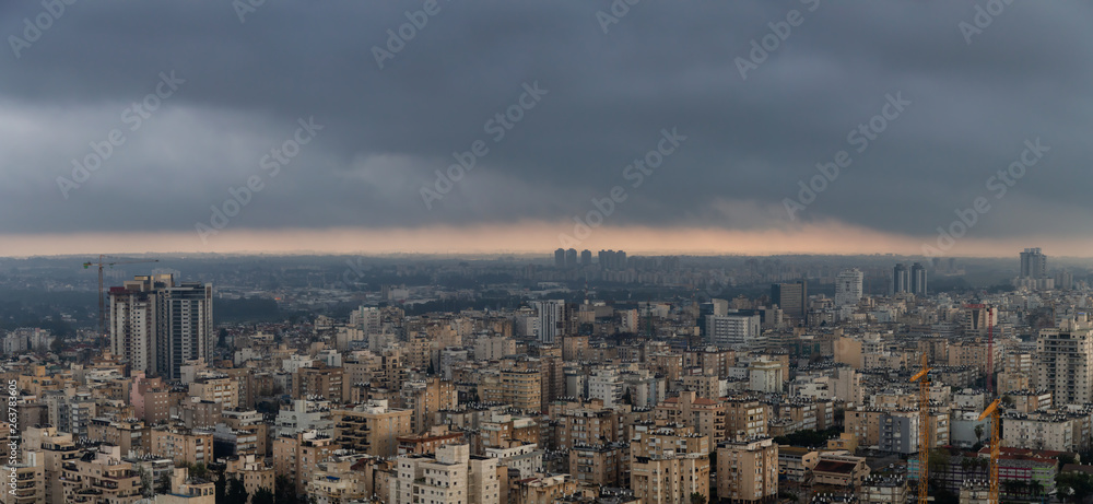 Aerial view of a residential neighborhood in a city during a cloudy sunrise. Taken in Netanya, Center District, Israel. Aerial view of a residential neighborhood in a city during a cloudy sunrise. Taken in Netanya, Center District, Israel.