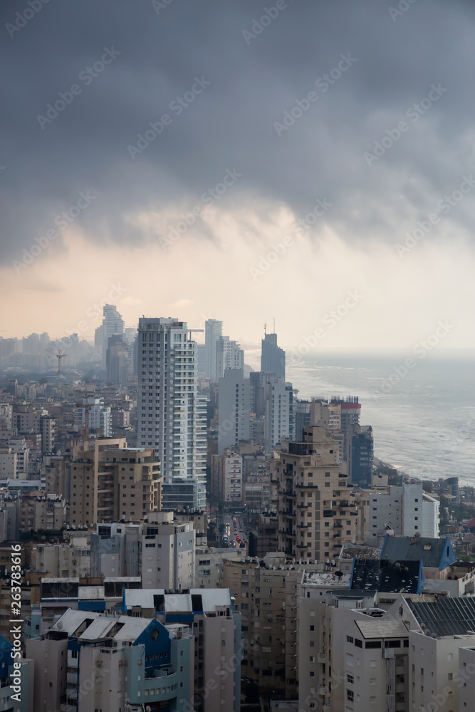 Aerial view of a residential neighborhood in a city during a cloudy sunrise. Taken in Netanya, Center District, Israel.