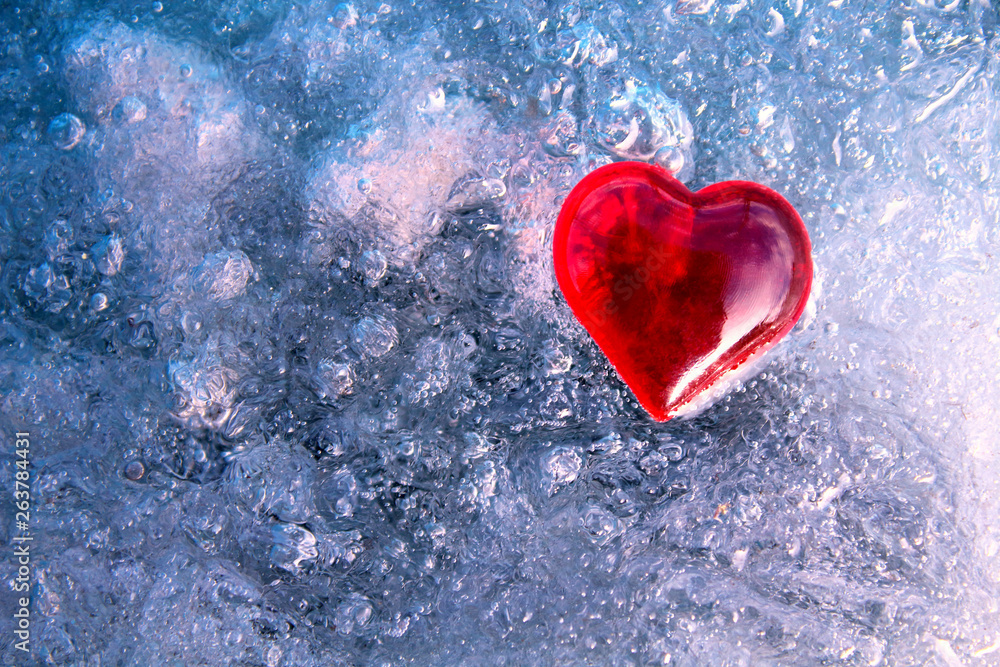 Red heart on ice. Close-up. Background. Texture. Red heart on ice. Close-up. Background. Texture.