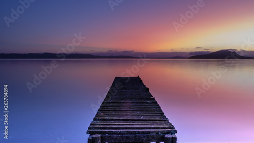 Jetty during sunrise at lake Rotorua, New Zealand