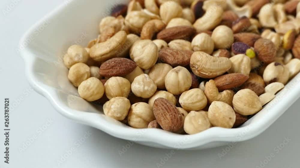 nuts, peeled hazelnuts, cashews and almonds, stand together, nuts, cashew nuts, dry almonds all on a plate close up nuts, peeled hazelnuts, cashews and almonds, stand together, nuts, cashew nuts, dry almonds all on a plate close up