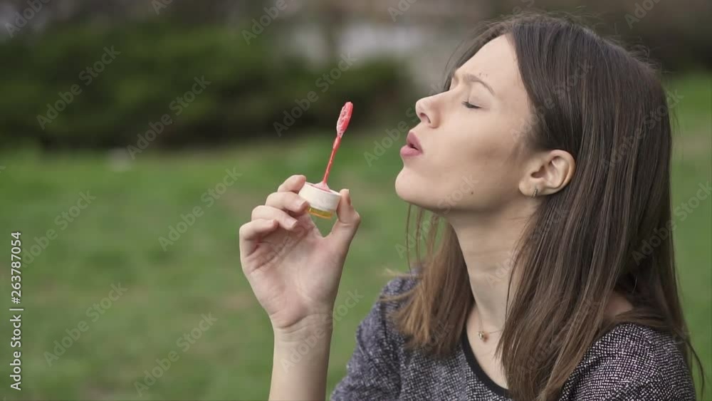 Beautiful Young Woman Making Soap Bubbles and Having Fun in the Park, Slow Motion Clip Beautiful Young Woman Making Soap Bubbles and Having Fun in the Park, Slow Motion Clip