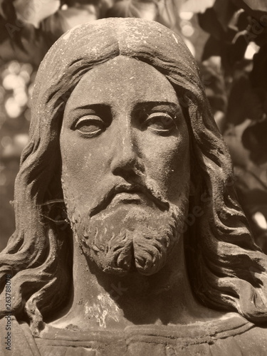 Christus face on grave in old abadoned cemetary, Detail of statue, nice sculpture close-up, sepia-tinted photos