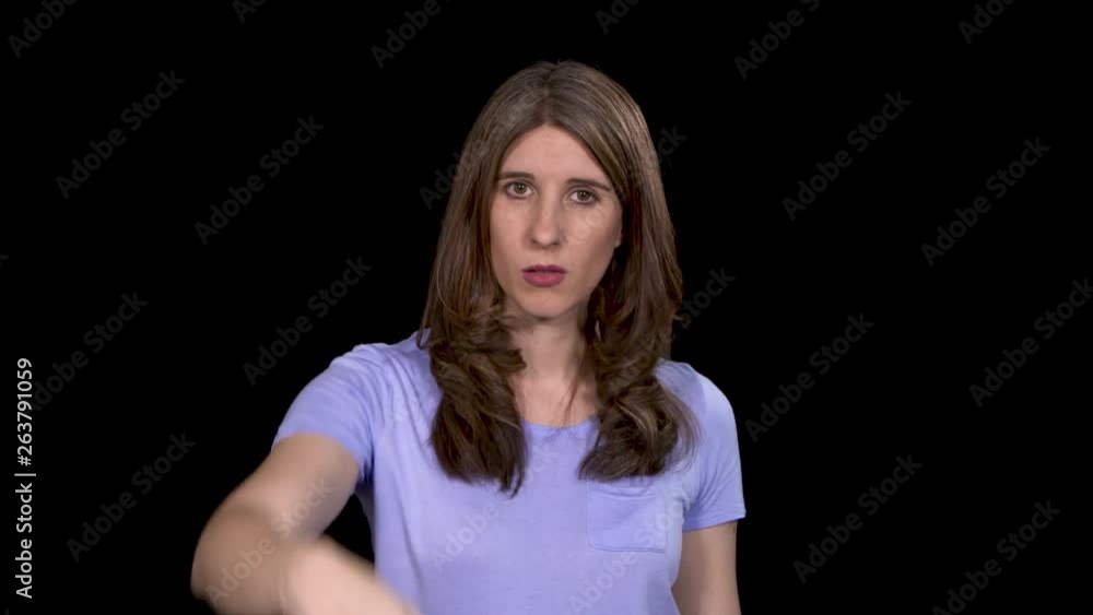 Close-up of a pretty brunette woman holding her hand up and shooing the viewer away Close-up of a pretty brunette woman holding her hand up and shooing the viewer away