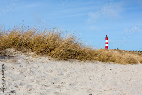 Red and white lighthouse on the hill