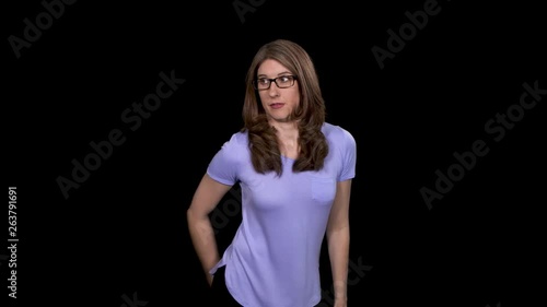 A pretty brunette woman farts and tries to fan away the smell