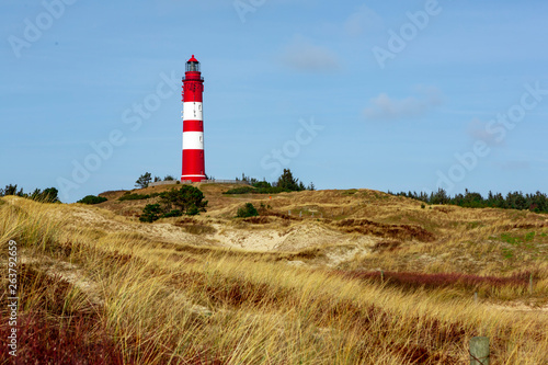 Red lighthouse on the hill in distance