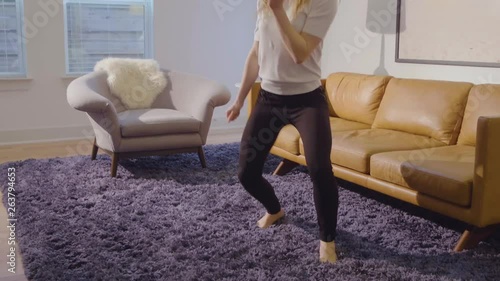 Slow motion shot of a young woman getting into her dance moves like nobodys watching, 23.98 fps. photo