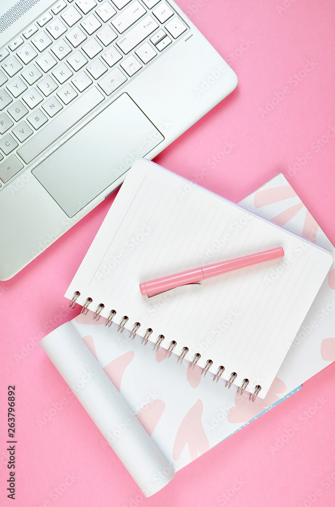 Ultra feminine cluttered pink desk workspace with touch screen laptop closeup, overhead flatlay. Ultra feminine cluttered pink desk workspace with touch screen laptop closeup, overhead flatlay.