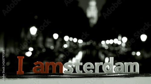Photography An inscription I amsterdam with a night Amsterdam channel on the background