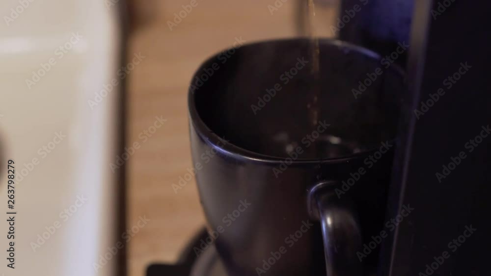 Coffee dripping into a coffee mug. Pan to the right. Shallow depth of field. 24 fps. 1080p. Coffee dripping into a coffee mug. Pan to the right. Shallow depth of field. 24 fps. 1080p.