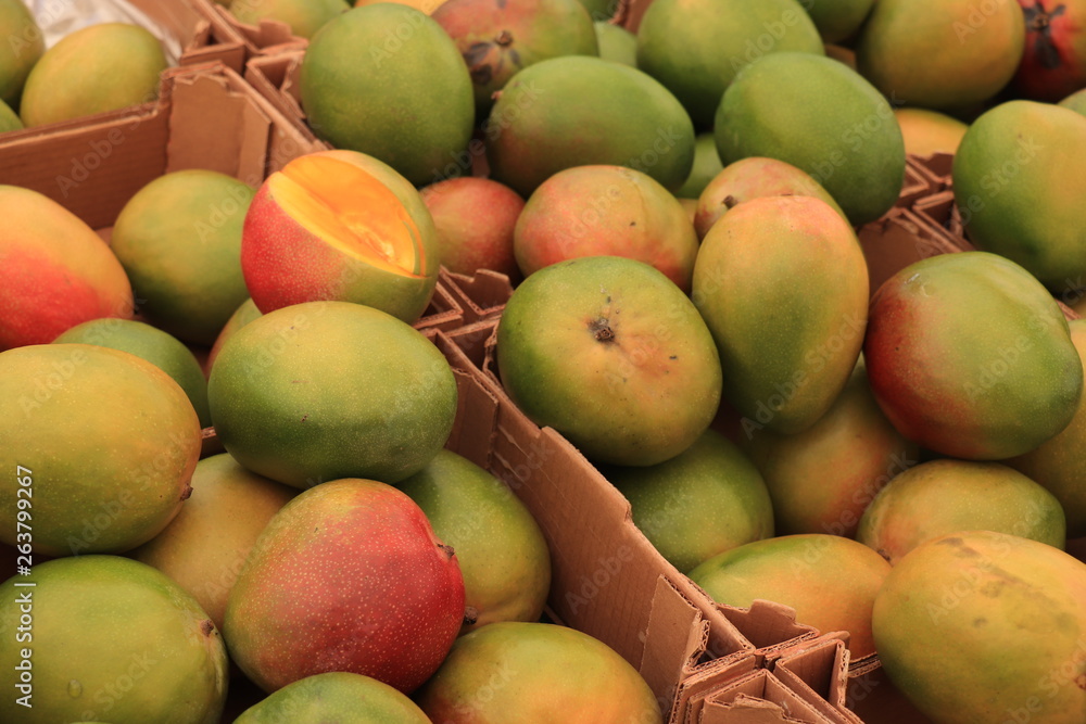 Fresh mangos on a market stall Fresh mangos on a market stall