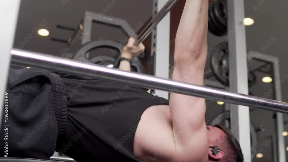 Person lifting weights and exercising in the gym. Pan to the right. 24 fps. Shot in 4k exported in 1080p. Shallow depth of field. Person lifting weights and exercising in the gym. Pan to the right. 24 fps. Shot in 4k exported in 1080p. Shallow depth of field.
