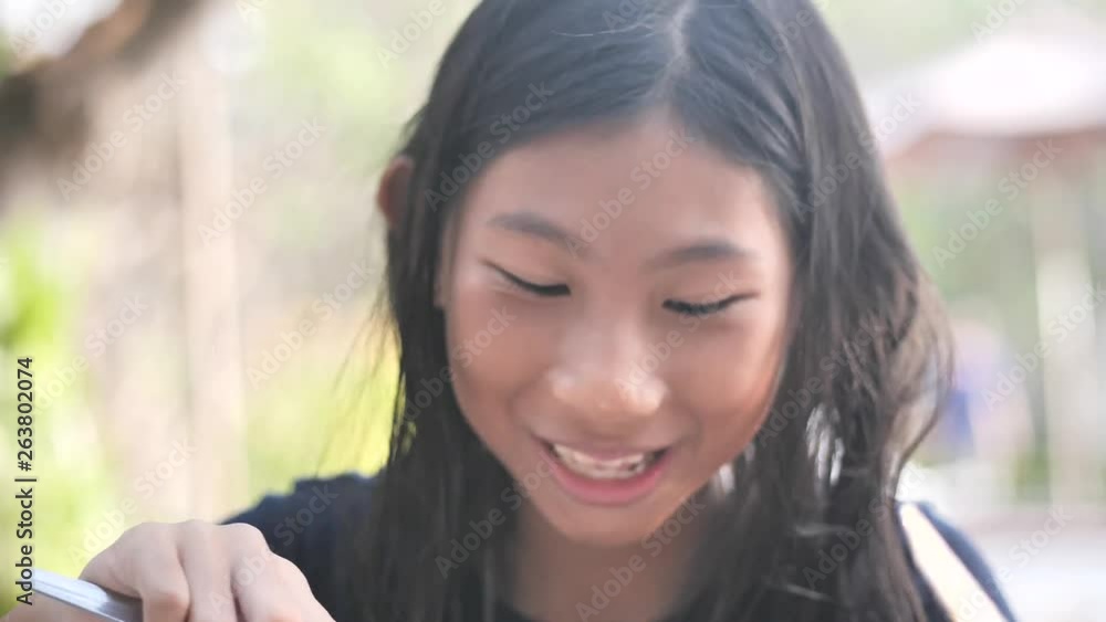 Happy Asian girl enjoy her breakfast outdoor, slow motion. Happy Asian girl enjoy her breakfast outdoor, slow motion.