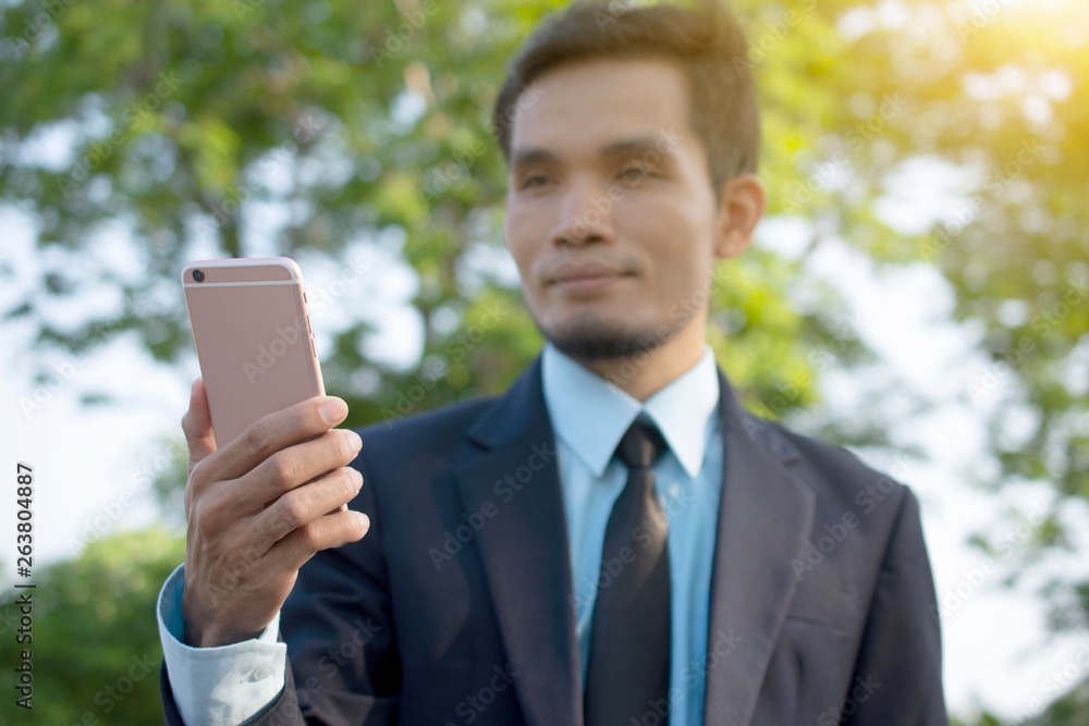 Businessman Holding Mobile Smart Phone and using Smart phone for Business connection Businessman Holding Mobile Smart Phone and using Smart phone for Business connection