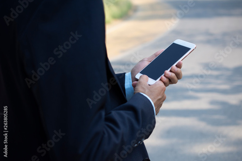 Businessman Holding Mobile Smart Phone and using Smart phone for Business connection
