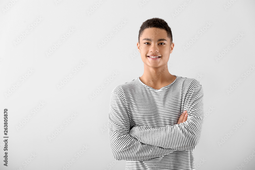Portrait of African-American teenage boy on grey background - obrazy, fototapety, plakaty 