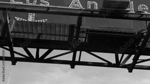 Hollywood 101 freeway sign black and white 1980s style hand held driving view. 