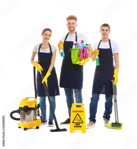 Team of janitors with cleaning supplies on white background