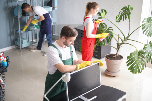 Team of janitors cleaning o...
