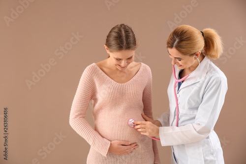 Gynecologist examining youn...