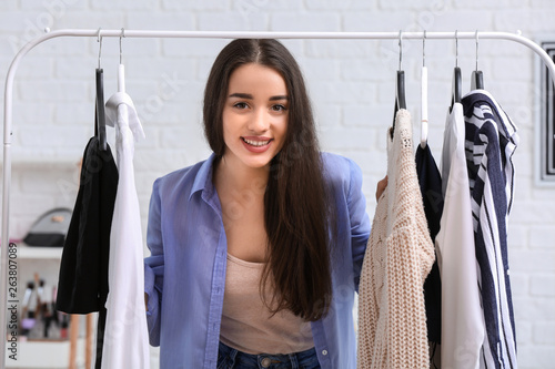 Young woman choosing clothe...
