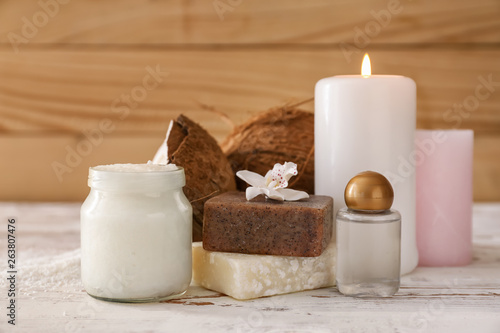 Jar with coconut oil  soap and candles on table