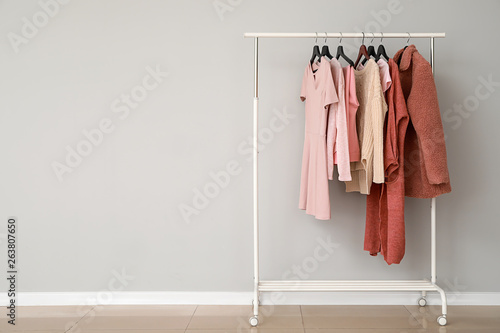Rack with stylish clothes near grey wall © Pixel-Shot