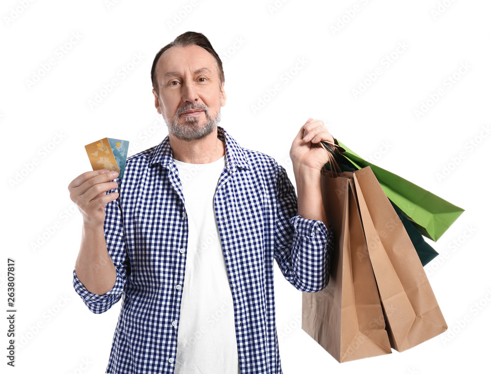 Portrait of handsome mature man with shopping bags and credit cards on white background Portrait of handsome mature man with shopping bags and credit cards on white background