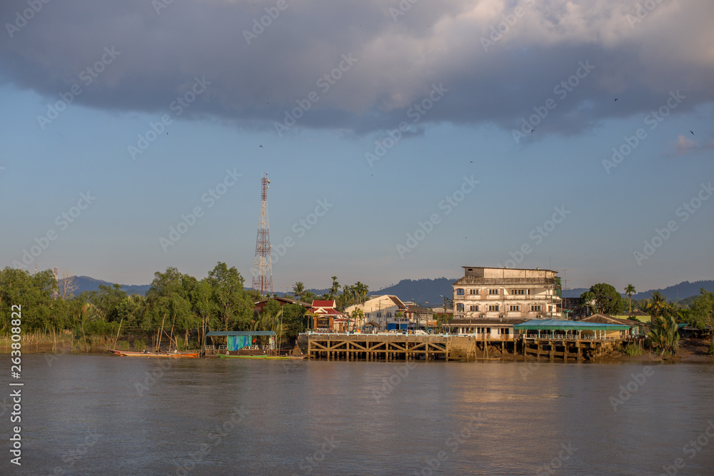 The background of a wooden house in the country (Myanmar village) where tourists can take pictures in public while traveling, surrounded by mountains,mangroves,trees,fresh air. 