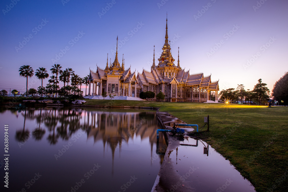 Obraz premium Wallpaper Wat Lan Boon Mahawihan Somdet Phra Buddhacharn(Wat Non Kum)is the beauty of the church that reflects the surface of the water, popular tourists come to make merit and take a public photo 