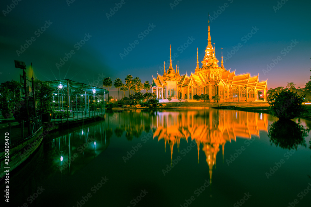 Fototapeta premium Wallpaper Wat Lan Boon Mahawihan Somdet Phra Buddhacharn(Wat Non Kum)is the beauty of the church that reflects the surface of the water, popular tourists come to make merit and take a public photo 