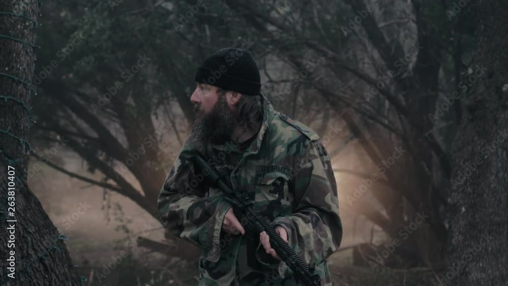 A hunter quietly stands in the cold misty forest, armed with a weapon & looks around for wildlife, 29.97 fps. A hunter quietly stands in the cold misty forest, armed with a weapon & looks around for wildlife, 29.97 fps.