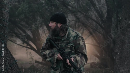 Wallpaper Mural A hunter quietly stands in the cold misty forest, armed with a weapon & looks around for wildlife, 29.97 fps. Torontodigital.ca