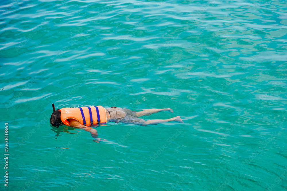 People swimming with life jacket on the ocean of Phu Quoc island, Vietnam | Enjoy holiday at the beach under the sun