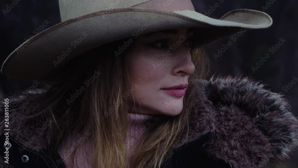 Close up of a woman wearing a cowboy hat standing quietly in the woods, listening carefully for wildlife, slow motion 23.98 fps. Close up of a woman wearing a cowboy hat standing quietly in the woods, listening carefully for wildlife, slow motion 23.98 fps.