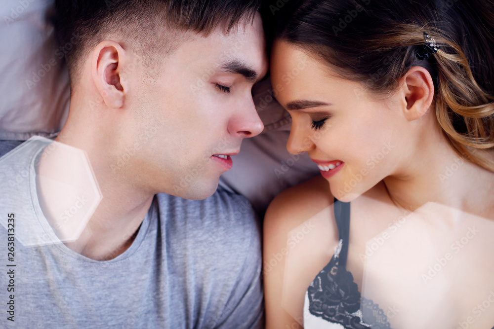Young couple sleeping together in bed. Young couple sleeping together in bed.