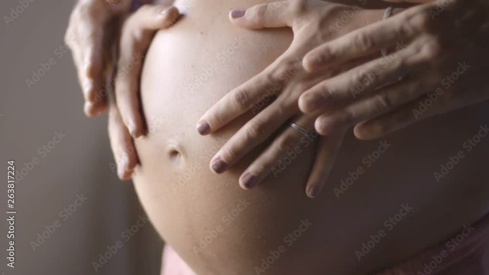 Mom and dad hands on pregnant tummy. Pregnant couple caressing pregnant belly. Happy family. pregnancy, motherhood, maternity, people and expectation concept. Mom and dad hands on pregnant tummy. Pregnant couple caressing pregnant belly. Happy family. pregnancy, motherhood, maternity, people and expectation concept.