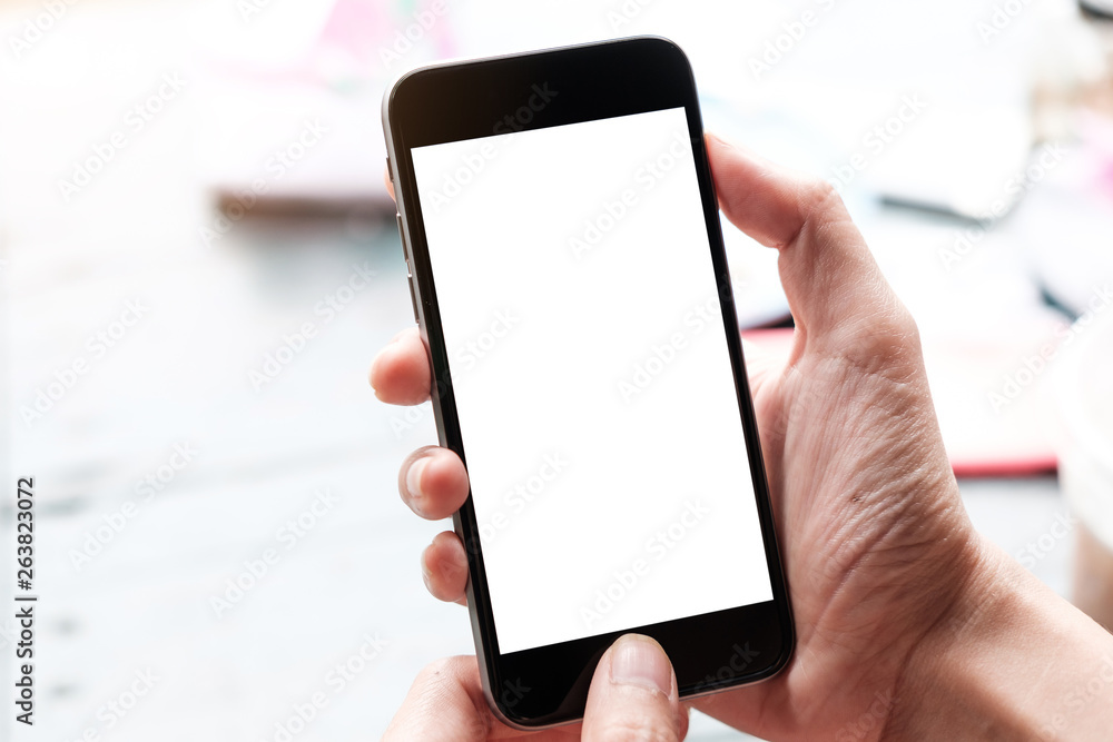 Man and mobile smartphone with blank screen on blur background