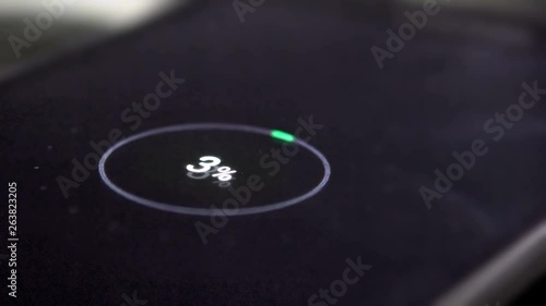 Low battery. Mobile smart phones charging on wooden desk. Cinematic dof