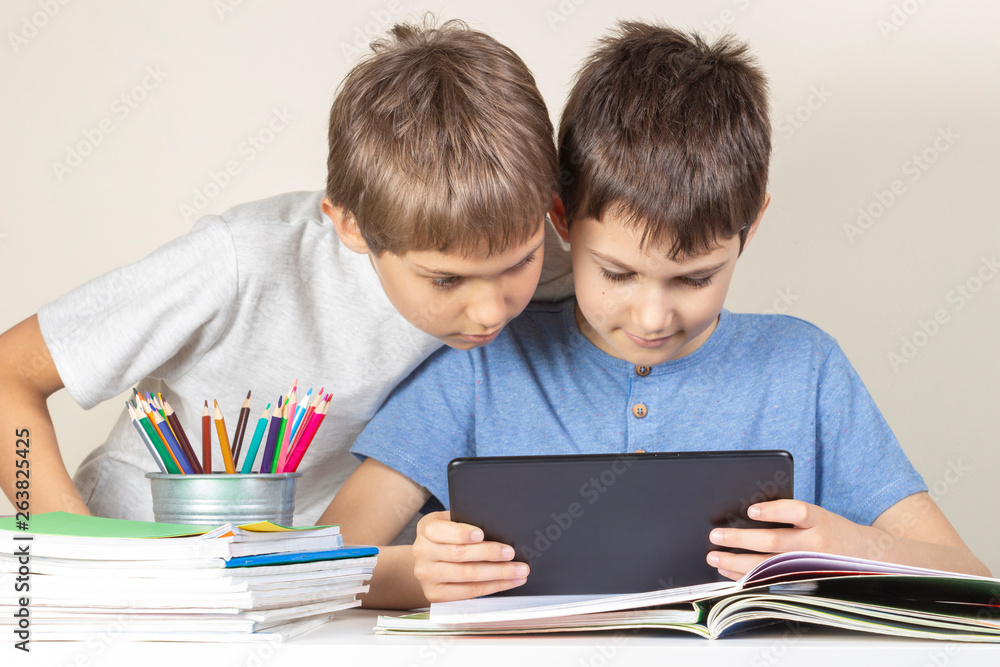 Kids using together tablet computer at home Kids using together tablet computer at home