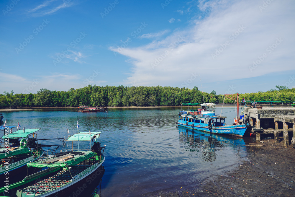 Naklejka premium Old wooden boat carrying goods at the pier