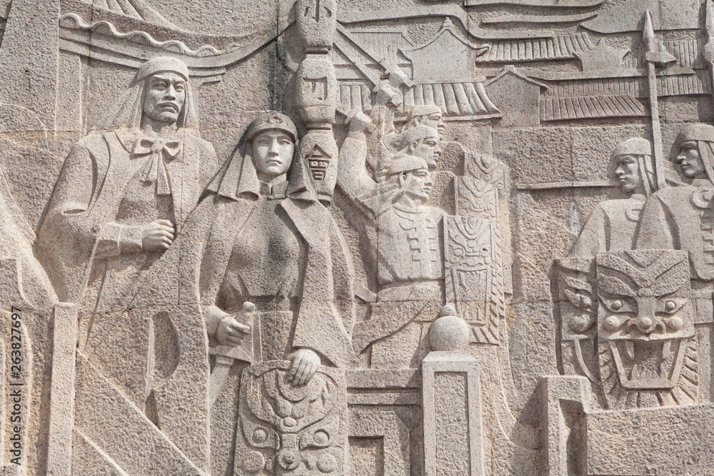 Fototapeta premium stone carving wall art of the 60' era in Shanghai,China.