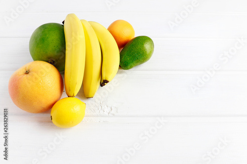Various fruits on white wooden background