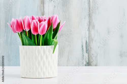 Fototapeta Naklejka Na Ścianę i Meble -  Pink tulips in white ceramic vase