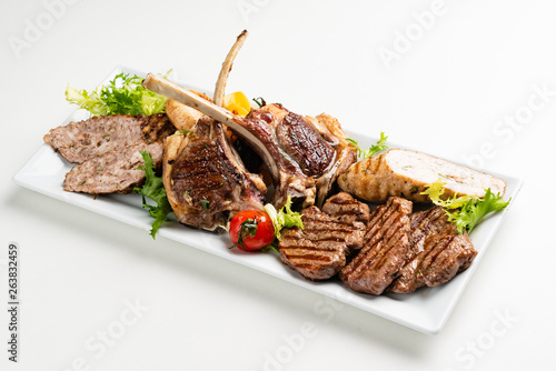 meat appetizer on the white plate photo