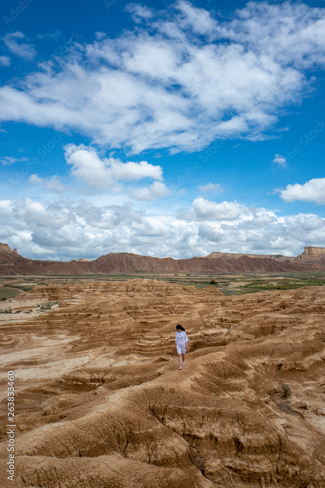 Woman walking in Bardenas Reales desert, Navarra, Spain Woman walking in Bardenas Reales desert, Navarra, Spain