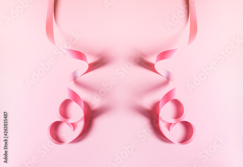 Pink ribbon on pink background