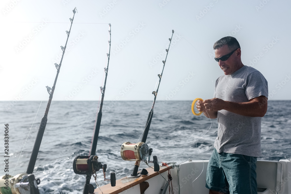 Man working on a fishing boat Man working on a fishing boat
