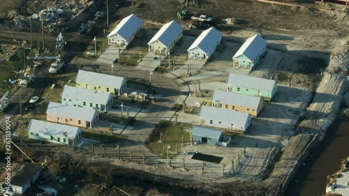 Aerial view property construction around hurricane damaged buildings photo